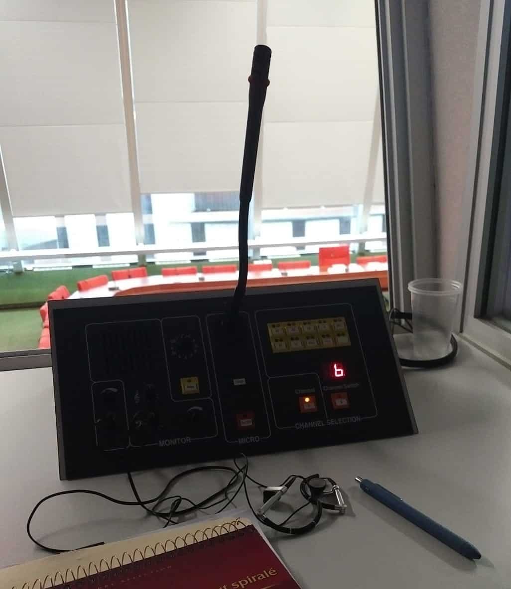 Interpreter console showing monitor section, microphone controls, and channel selection panel with digital display